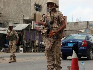 Loyalist forces stand guard on a main road in Al Mansoura district. (AFP/ File)