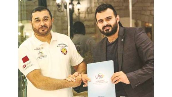  Qatari rally driver Khalid al-Mohannadi (left) with Universal Sports’ marketing director Zaid Yaaroub after signing a sponsorship agreement. (Photo: Gulf Times)