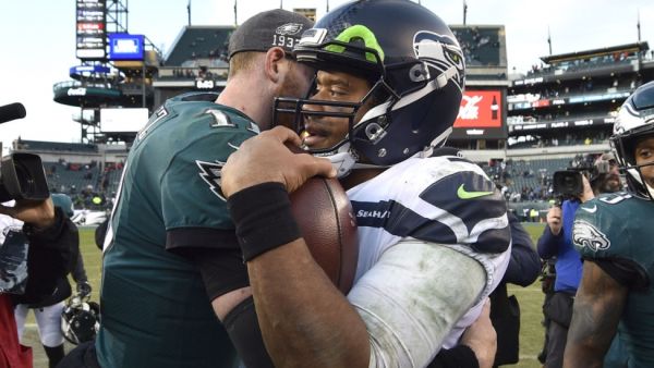 NFL players like Seattle Seahawks quarterback Russell Wilson (R) and Philadelphia Eagles quarterback Carson Wentz (L) must remain six feet apart and will not be allowed to trade jerseys after games during the 2020 season. (Photo: Derik Hamilton/UPI)