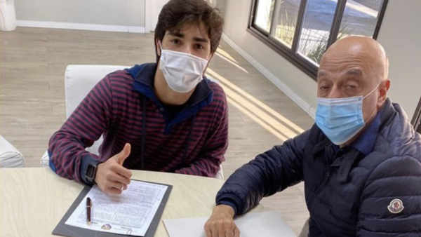 Brazilian teenager Erik Jorgens de Menezes (left) signs the contract. - (Al Ain FC Twitter)