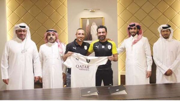 Santi Cazorla (centre) poses with Al Sadd’s head coach Xavi Hernandez (second from right) and other club officials after signing a two-year contract. (Photo: Gulf Times)