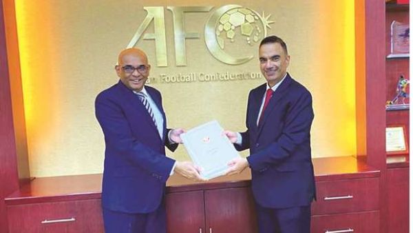 Qatar’s ambassador to Malaysia Fahd bin Mohamed Kafood (right) presents the nation’s bid file for 2027 Asian Cup to AFC Secretary-General Windsor John in Kuala Lumpur. (Photo: Gulf Times)