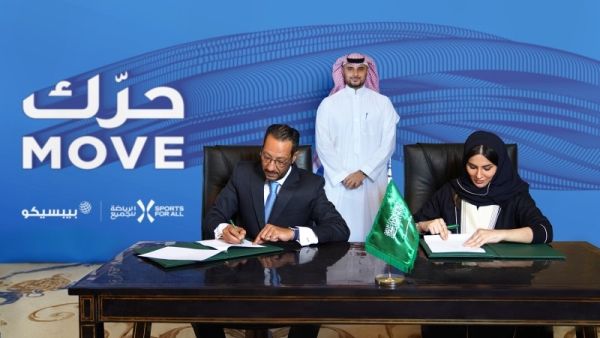 SFA Managing Director Shaima Saleh Al-Husseini and Tamer Mosalam, Gulf & Levant Foods Vice President and Business Unit General Manager at PepsiCo, signing a partnership deal on Sunday. (Courtesy photo)