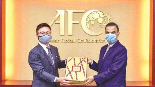 Qatar’s Ambassador to Malaysia Fahd bin Mohammed Kafoud (right) hands over the final part of the bid documents for the 2027 AFC Asian Cup to an Asian Football Confederation official. (Photo: Gulf Times)