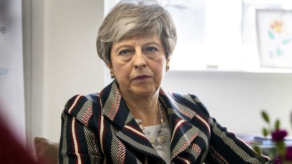 Britain's Prime Minister Theresa May talks with case workers and domestic violence survivors on a visit to a charity providing support for victims of domestic violence in west London on May 13, 2019. (Victoria Jones / POOL / AFP)