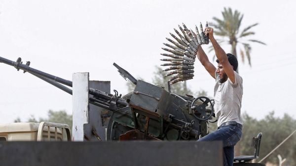 A fighter loyal to the Libyan internationally-recognised Government of National Accord (GNA) loads a heavy machine gun during clashes against forces loyal to strongman Khalifa Haftar. (AFP/ File)