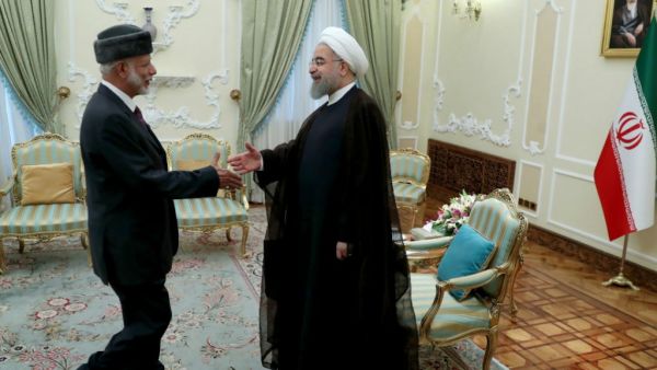 Iranian President Hassan Rouhani (R) greeting Oman's Foreign Minister Yusuf bin Alawi in Tehran. (AFP/ File Photo)