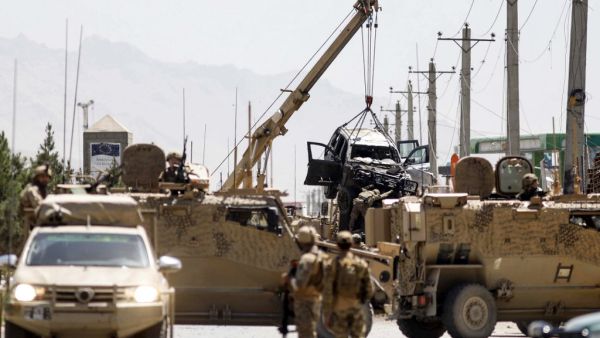 International forces belonging to NATO's Resolute Support mission remove a damage vehicle with a crane at the site of a car bomb attack in Kabul on May 31, 2019. (AFP/File Photo)