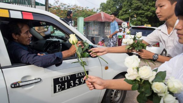 Buddhists give white roses to Muslims as they attend prayers during Eid al-Fitr at Than Lyin township on the outskirts of Yangon on June 5, 2019. (AFP/ File)