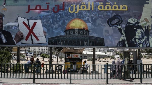 A picture taken on June 16, 2019, shows a poster in Gaza City denouncing the US Middle East peace plan dubbed the "deal of the century". Arabic writing on poster reads "The deal of the century will not pass".  (MAHMUD HAMS / AFP)