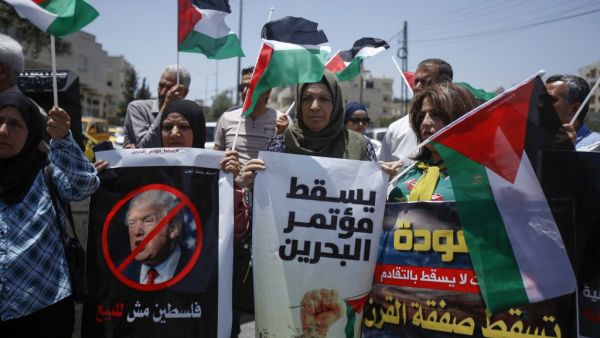 Palestinians hold banners and shout slogans as they rally against the US-led Israeli-Palestinian peace conference in Bahrain scheduled for next week, in Bethlehem in the occupied West Bank on June 20, 2019. (Musa AL SHAER / AFP)
