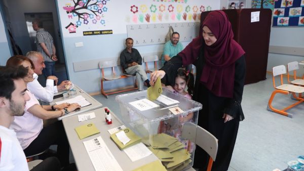 A woman, flanked by a girl, casts her vote at a polling station during Istanbul mayoral elections re-run, in Istanbul. Istanbul went back to the polls on June 23, 2019 in a re-run of the mayoral election. (AFP/ File Photo)