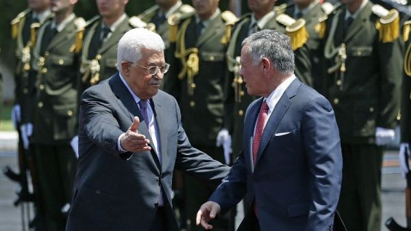 Jordan's King Abdullah II (right) speaks with Palestinian Authority President Mahmoud Abbas upon his arrival in the West Bank city of Ramallah on August 7, 2017. (AFP/ ABBAS MOMANI)