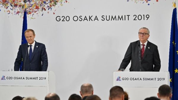 Tusk and European Commission President Jean-Claude Juncker attend a press conference at the G20 Osaka Summit  (AFP)
