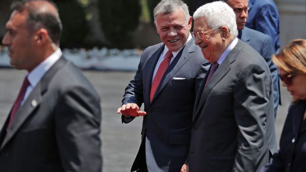Jordan's King Abdullah II, center, walks Monday with Palestinian leader Mahmoud Abbas. (AHMAD GHARABLI/Getty-AFP )
