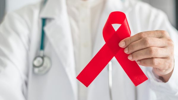 Aids red ribbon in doctor's hand for World aids day and national HIV/AIDS and aging awareness month concept. (Shutterstock/ File Photo)