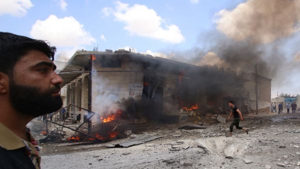 Syrian civilians react following an airstrike by Syrian regime forces in Maar Shurin on the outskirts of Maaret al-Numan in northwest Syria  (AFP)