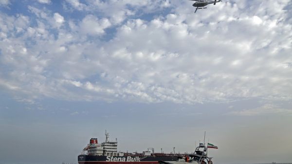 Iranian Revolutionary Guards patrolling around the British-flagged tanker Stena Impero as it's anchored off the Iranian port city of Bandar Abbas  (AFP)