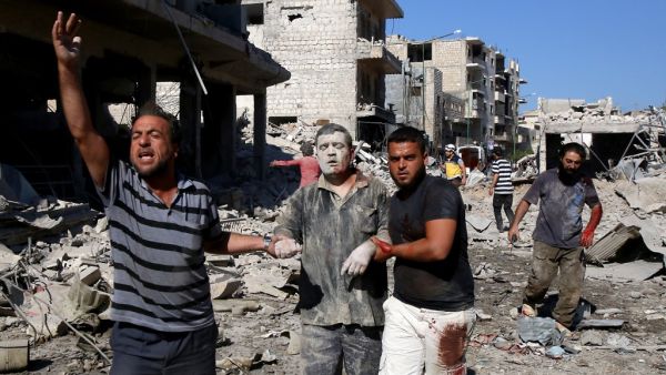 Syrians help a man pulled out from the rubble of a destroyed building following a reported Russian air strike on July 22, 2019 on Maaret al-Numan in Syria's northwestern Idlib province. (AFP/ File Photo)