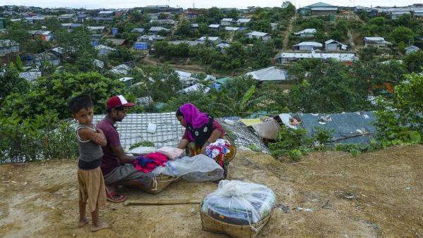 A Rohingya woman buy cloths from a vendor at Kutupalong refugee camp in Ukhia on July 24, 2019. (MUNIR UZ ZAMAN / AFP)