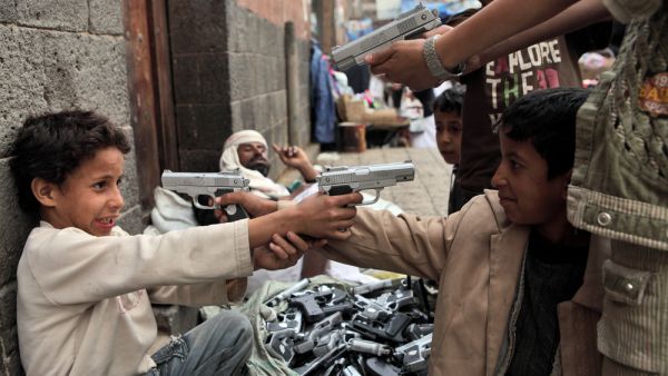 Children playing with toy guns on the street of Sanaa (Shutterstock)	