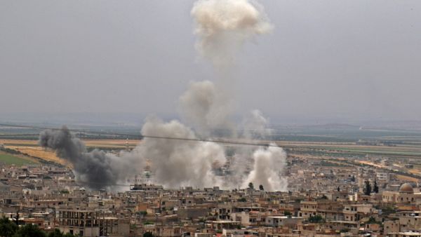 Smoke rising following reported Syrian government forces' bombardment on the town of Khan Sheikhun in the southern countryside of the rebel-held Idlib province (AFP)