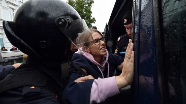 Police officers detain opposition politician, would-be candidate Lyubov Sobol on her way to an unsanctioned rally urging fair elections in downtown Moscow (AFP)