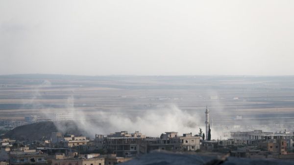 A smoke billowing above buildings during a reported air strike by pro-regime forces on Khan Sheikhun in the south of the northwestern Syrian province of Idlib. (AFP)