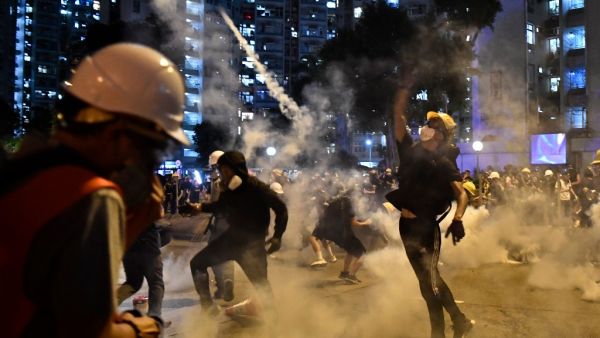 Protesters throw back tear gas fired by the police in Wong Tai Sin during a general strike in Hong Kong on August 5, 2019, as simultaneous rallies were held across seven districts. (AFP/ File Photo)
