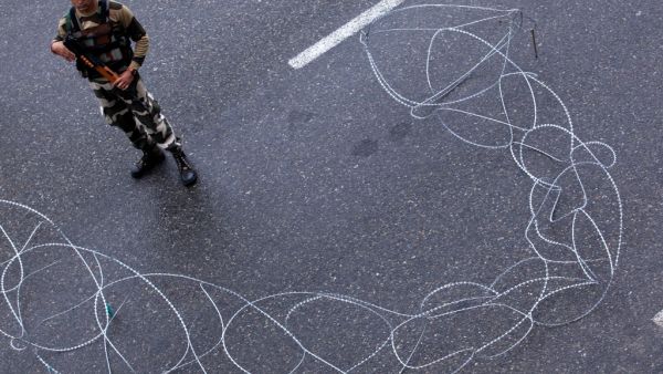 A security personnel stands guard at a roadblock in Jammu (AFP)