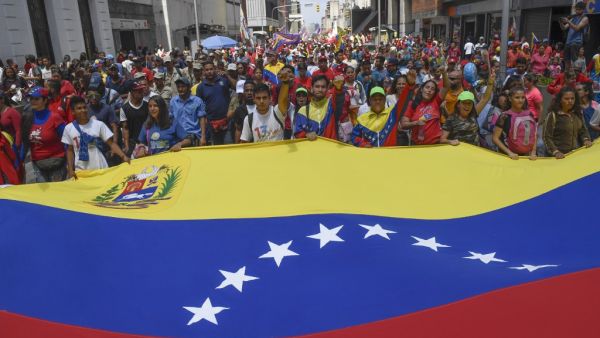 Pro-government protesters rally against US sanctions with a Venezuelan national flag in Caracas on August 7, 2019. (AFP/ File Photo)