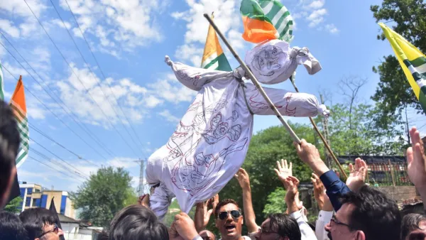 Pakistani Kashmiri hold an effigy of Indian Prime Minister Narendra Modi during a protest in Muzaffarabad, the capital of Pakistan-controlled Kashmir, on August 8, 2019. 