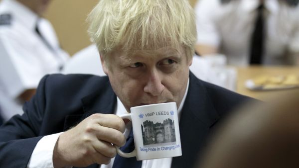Britain's Prime Minister Boris Johnson drinks from a HMP Leeds prison mug (AFP/ File Photo)