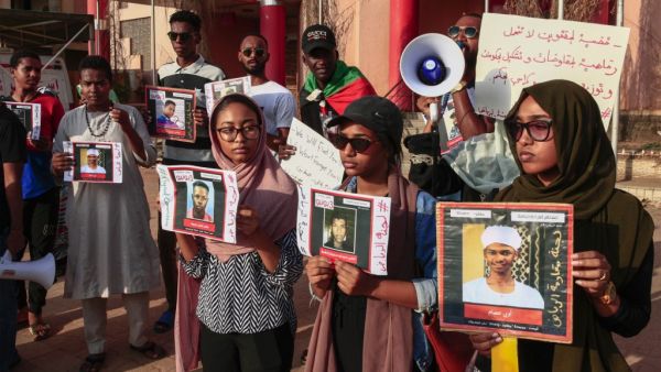 Sudanese protesters hold posters bearing the portraits of missing people during a rally in the capital Khartoum on august 30, 2019, marking the International Day of the Disappeared. Hundreds of Sudanese took to the streets to demand answers on the whereabouts of demonstrators missing since the deadly dispersal of a protest camp in June.  Ebrahim HAMID / AFP