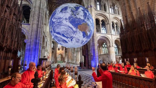 Choristers from Holy Trinity Church Coventry rehearse for evensong as Gaia, a 23ft replica of planet earth hangs on display (dailymail.co.uk)