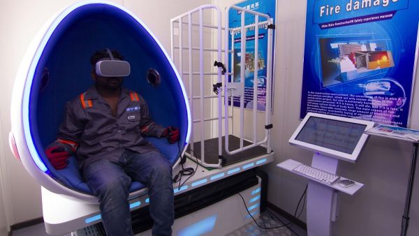 Construction workers experience simulated hazard - management training in the Virtual Reality Pods at DAMAC's AYKON City.