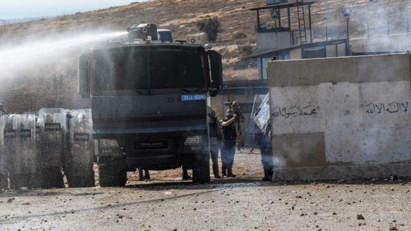 Members of the Turkish gendarmerie fire tear gas and water cannon to disperse a demonstration by displaced Syrians along the border with Turkey. (AFP/ File Photo)