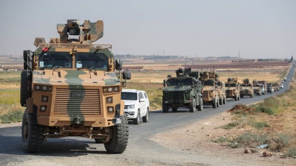 A picture taken on September 1, 2019 shows a convoy of Turkish military vehicles passing through the village of Kafr Halab on the western edge of Aleppo province.  (Omar HAJ KADOUR / AFP)