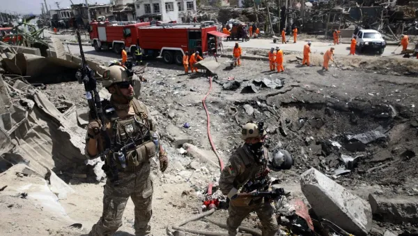 Afghan security forces walks as municipal workers gather to clean up near the crater from where a tractor packed with explosives exploded the night before at the Green Village in Kabul on September 3, 2019. (AFP/ File Photo)