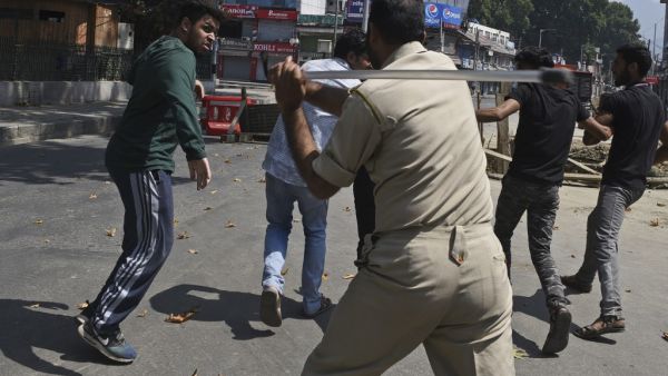 An Indian policeman clashes with Indian Kashmiri Shiite during a strict curfew in Lal Chowk area of Srinagar (AFP) An Indian policeman clashes with Indian Kashmiri Shiite during a strict curfew in Lal Chowk area of Srinagar (AFP)