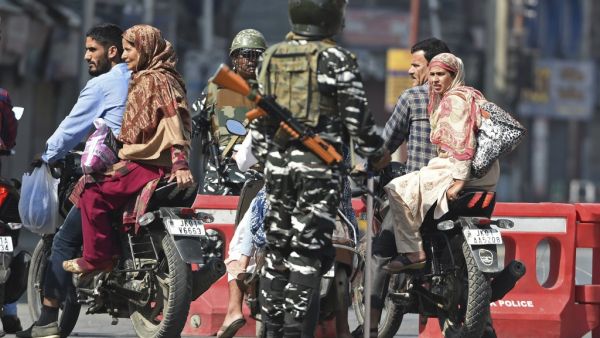 Indian paramilitary troopers stop Indian Kashmiri motorcyclists during a strict curfew in Lal Chowk (AFP) Indian paramilitary troopers stop Indian Kashmiri motorcyclists during a strict curfew in Lal Chowk (AFP)