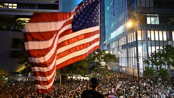A man waves a US national flag as protesters attend a rally in Hong Kong on October 14, 2019, calling on US politicians to pass a bill that could alter Washington's relationship with the trading hub. (AFP/ File Photo)