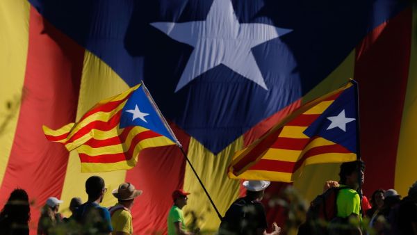 Protesters hold Catalan pro-independence "Estelada" flag as they walk on the AP-7 highway near Girona, on October 16, 2019, a day after police arrested 51 people across Catalonia overnight after violent protests over the jailing of nine separatist leaders for their role in a failed 2017 independence bid. (Pau Barrena / AFP) Protesters hold Catalan pro-independence "Estelada" flag as they walk on the AP-7 highway near Girona, on October 16, 2019, a day after police arrested 51 people across Catalonia overnight after violent protests over the jailing of nine separatist leaders for their role in a failed 2017 independence bid. (Pau Barrena / AFP)