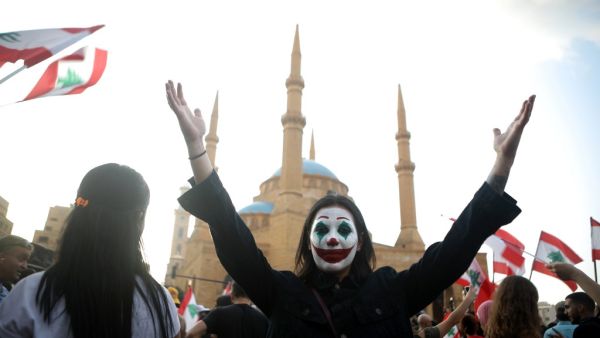 A Lebanese demonstrator, her face painted as DC comic book and film character "The Joker", takes part in a protest in the capital Beirut's downtown district's Martyr's Square on October 19, 2019. (AFP/ File Photo)