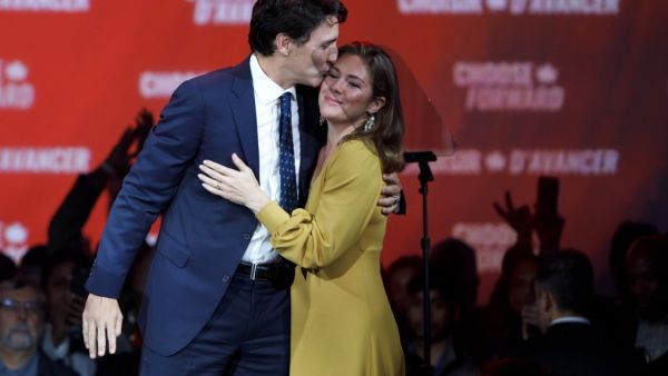 Liberal Leader and Canadian Prime Minister Justin Trudeau kisses his wife Sophie Grégoire Trudeau after delivering his victory speech at his election night headquarters  (AFP)