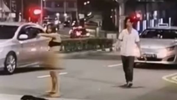 Shocking footage shows the 31-year-old chasing and yelling out to the taxi driver around 2am on Middle Road in Singapore. (Facebook/@ROADS.sg)