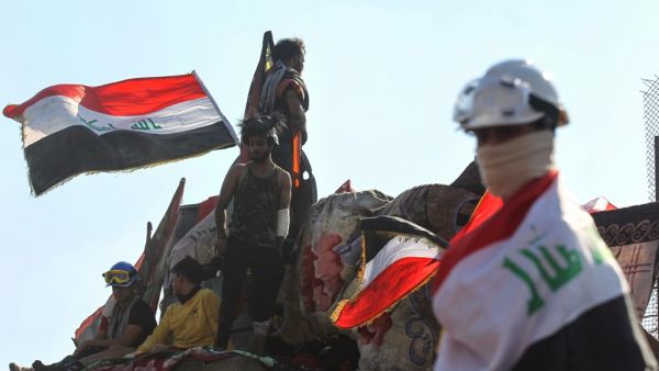 Iraqi protesters gather on al-Jumhuriya bridge which leads to the high-security Green Zone, during ongoing anti-government demonstrations in the capital Baghdad (AFP)