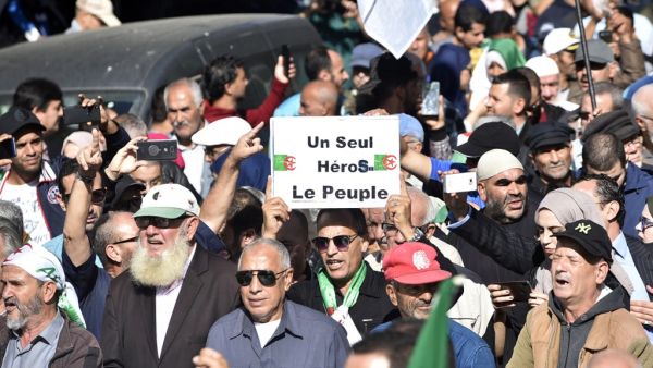 Algerians march through the streets of central Algiers as anti-government demonstrations continue on November 5, 2019. French slogan on placard reads: "One hero only, the People." (AFP/ File Photo)