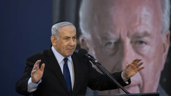 Israeli Prime Minister Benjamin Netanyahu speaks during a state memorial ceremony for former Israeli prime minister Yitzhak Rabin (backround) and his wife Leah, at Mount Herzl in Jerusalem on November 10, 2019.  (HEIDI LEVINE / POOL / AFP)