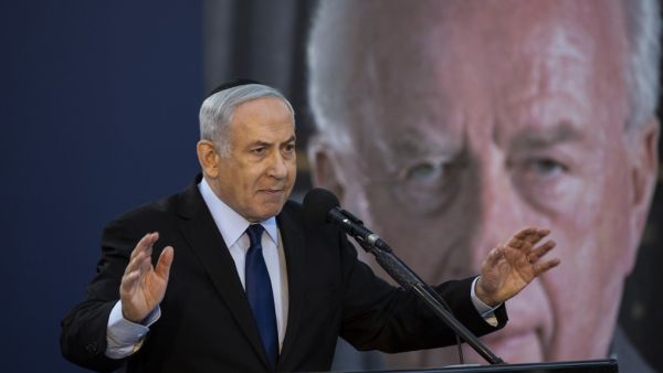 Israeli Prime Minister Benjamin Netanyahu speaks during a state memorial ceremony for former Israeli prime minister Yitzhak Rabin (backround) and his wife Leah, at Mount Herzl in Jerusalem on November 10, 2019.  (HEIDI LEVINE / POOL / AFP) Israeli Prime Minister Benjamin Netanyahu speaks during a state memorial ceremony for former Israeli prime minister Yitzhak Rabin (backround) and his wife Leah, at Mount Herzl in Jerusalem on November 10, 2019.  (HEIDI LEVINE / POOL / AFP)